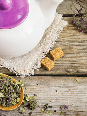 White teapot, dry herbal tea and brown sugar. with space for text