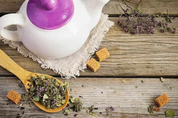 White teapot, dry herbal tea and brown sugar. with space for text