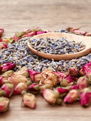 Dried roses and lavender flowers tea on wooden background